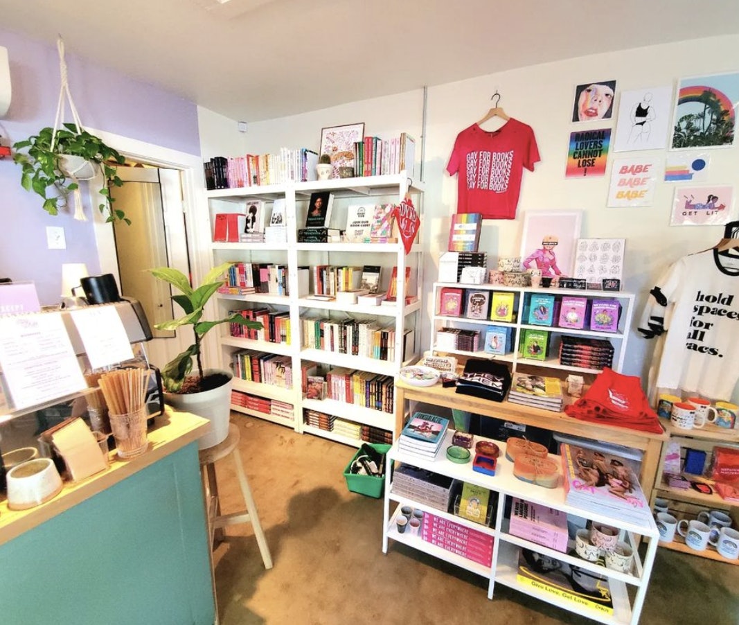 The inside of Austin's Little Gay Shop - there are t-shirts, books and artwork on the walls