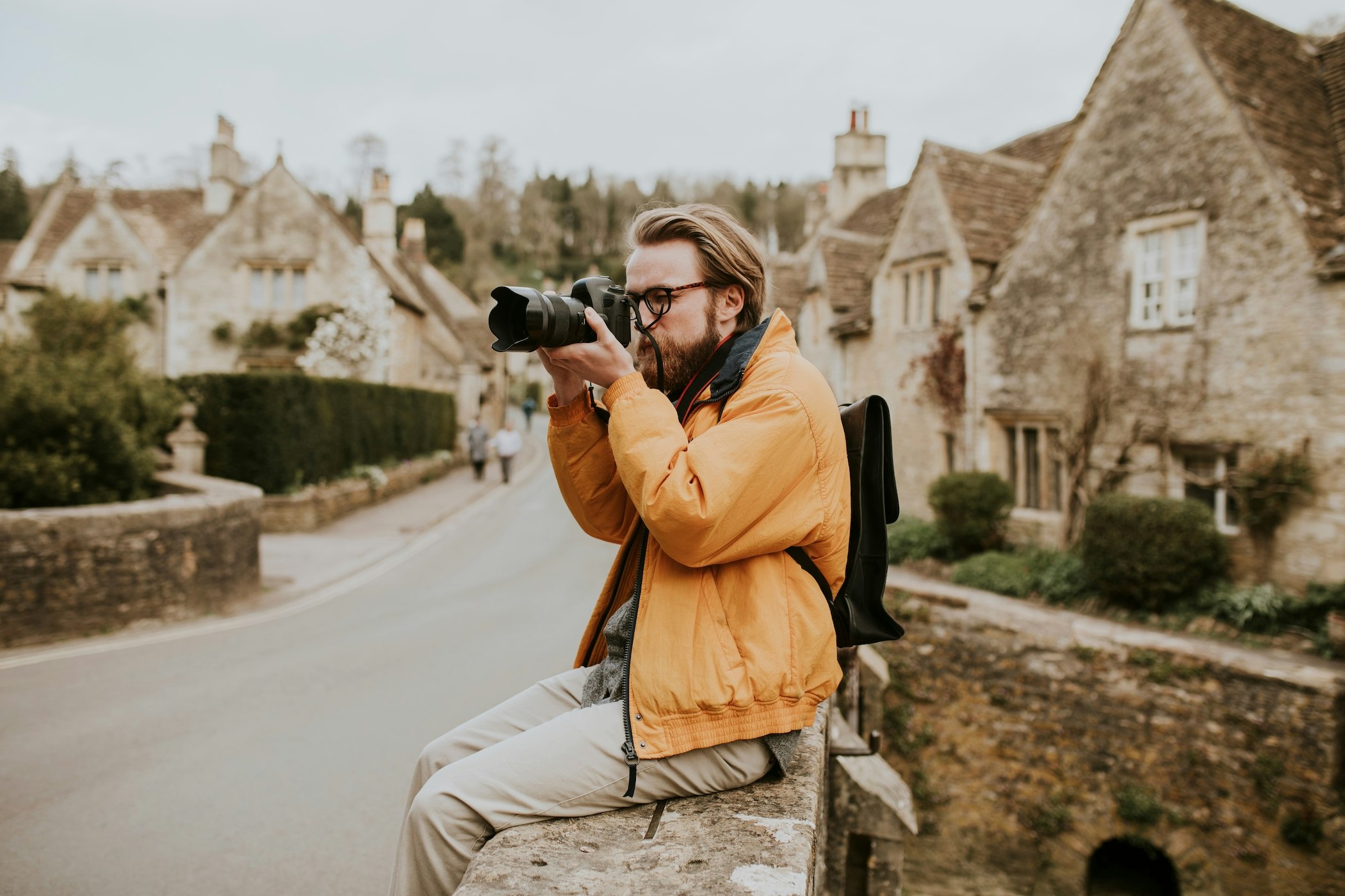 Photographer man taking photos in the village in Cotswolds, UK; Shutterstock ID 2039173658; your: Brian Healy; gl: 65050; netsuite: Lonely Planet Online Editorial; full: When to travel to the Cotswolds