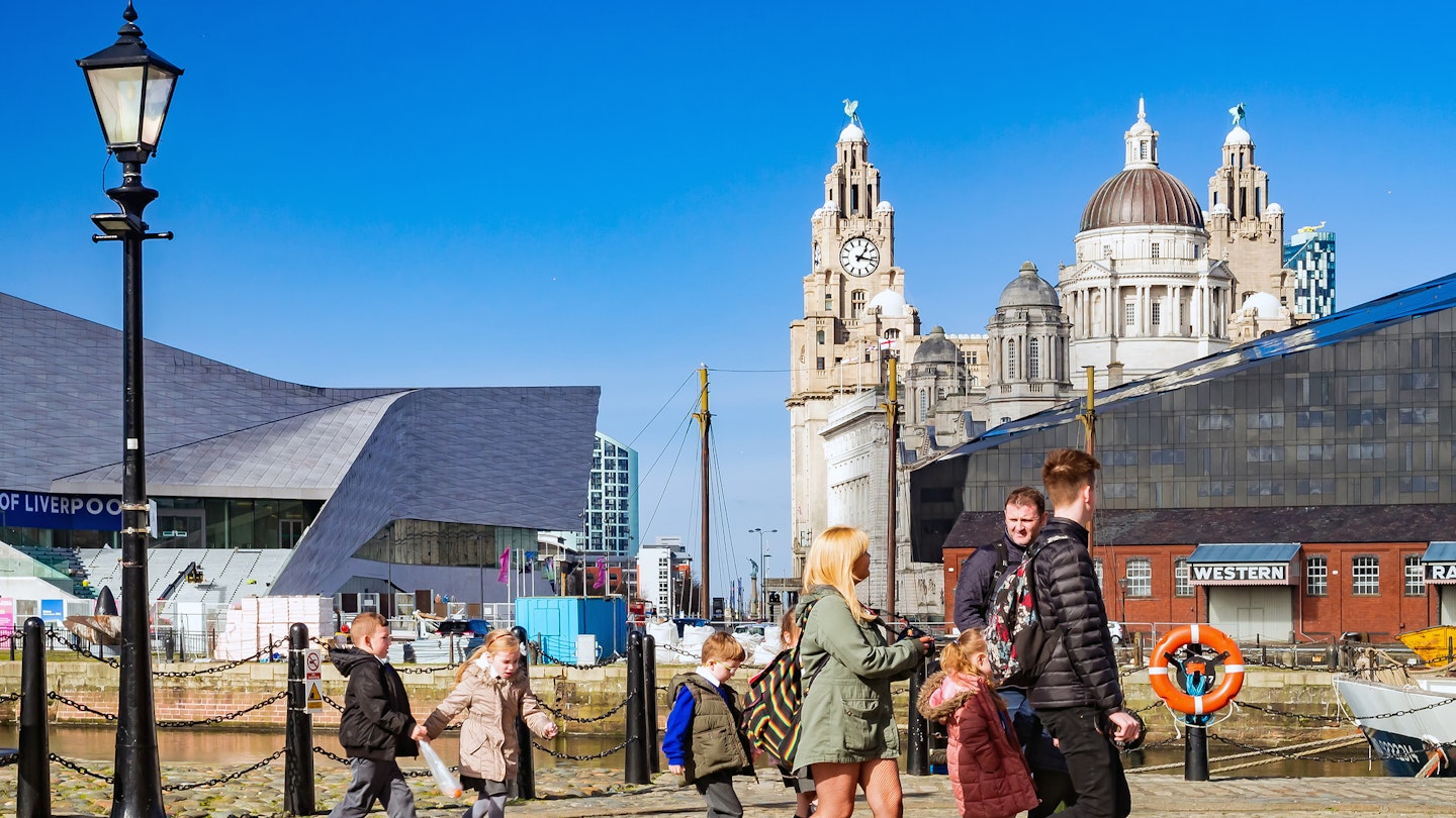 England, Liverpool..A view of the Albert Dock and Pier Head area at the Port of Liverpool and Royal Liver building part of the well known "The three Graces"..There were a group of teachers and some students leaving the Albert Docks after they paid a visit to this UNESCO Maritime World Heritage.