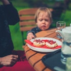 Mother and toddler enjoying cream tea in a garden the proper way with jam on top of the cream; Shutterstock ID 1099937564; your: Brian Healy; gl: 65050 ; netsuite: Lonely Planet Online Editorial; full: Dining in the Cotswolds