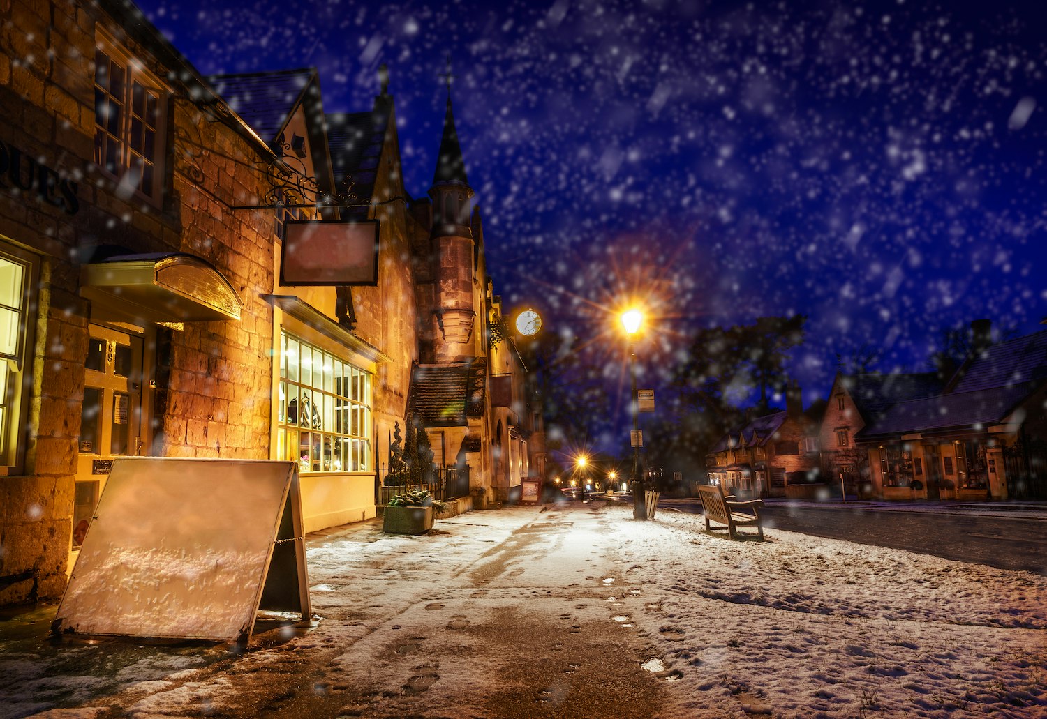 High Street at night during light snowfall, Broadway, Gloucestershire, the Cotswolds, England, United Kingdom