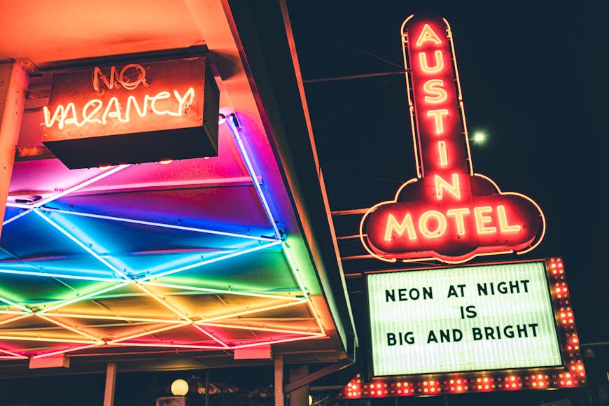 A neon-covered hotel with brightly lit signs saying No Vacancy in Austin, Texas