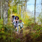 Differently-abled daughter and family walking on Appalachian Trail in Bryson City, carrying backpacks