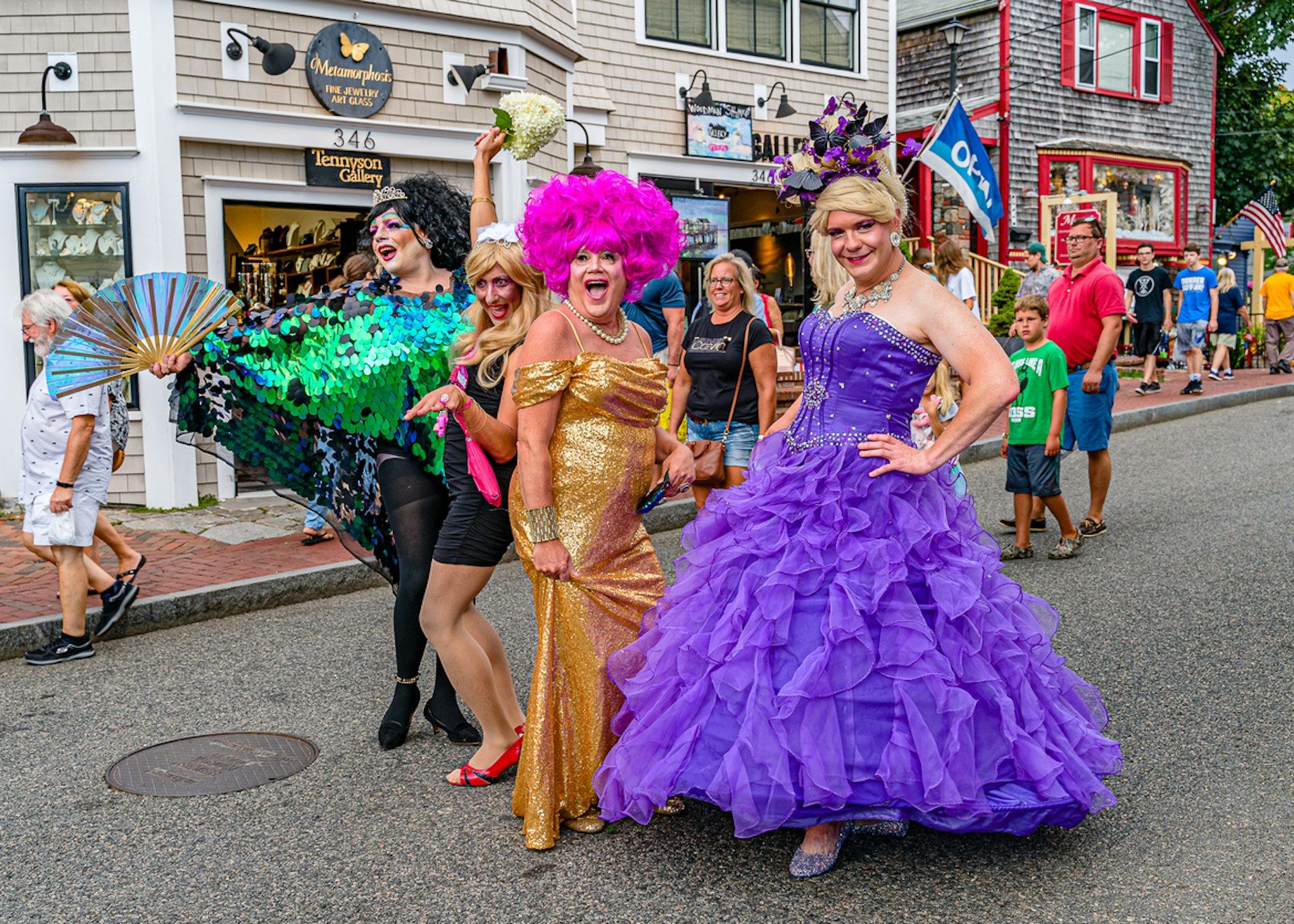 People in drag smile at the camera in Provincetown