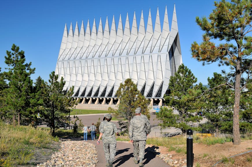 Cadets and servicemen walk toward the Cadet Chapel at the US Air Force Academy, Colorado Springs, Colorado, USA