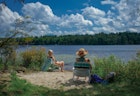 Pocono Lake, PA USA - April 6, 2021: Two Women Sitting by Pocono Lake to Cool Off From Summer Heat; Shutterstock ID 1950967123; your: Brian Healy; gl: 65050; netsuite: Lonely Planet Online Editorial; full: Best time to visit the Poconos