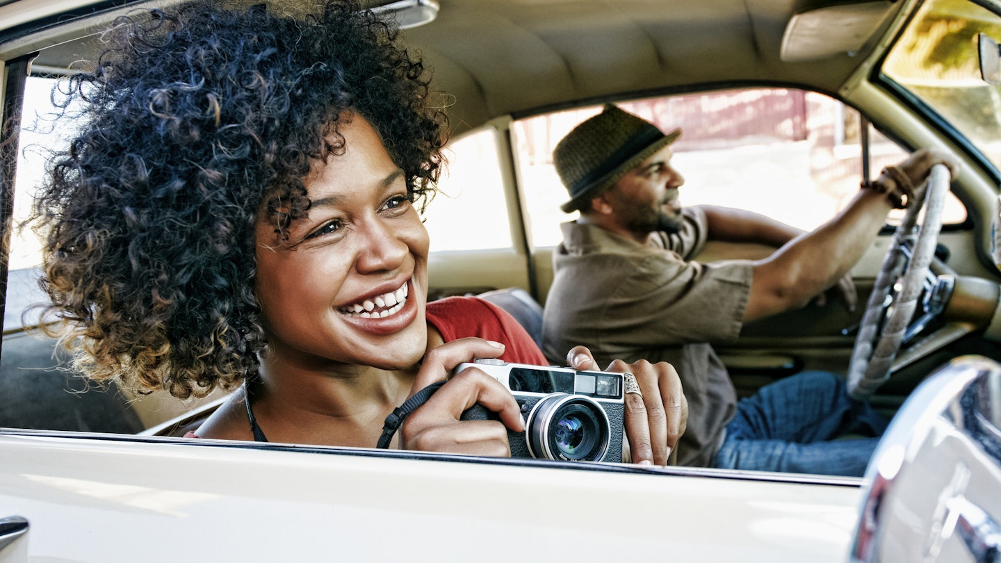 Couple driving in vintage car