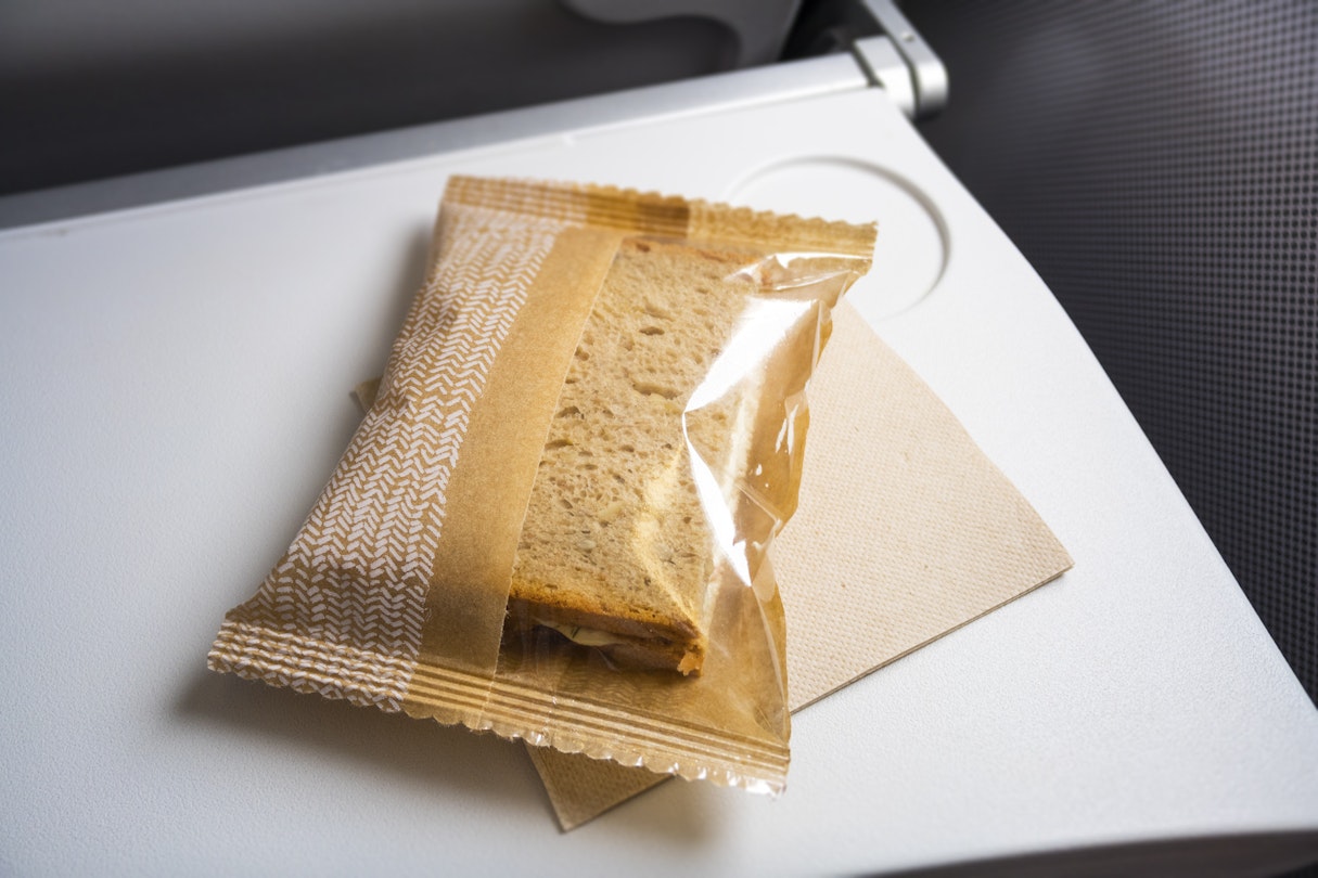 An image of a very small snack at the plane; Shutterstock ID 465639626; your: Fionnuala McCarthy; gl: 65050; netsuite: ONLINE EDITORIAL; full: airline food