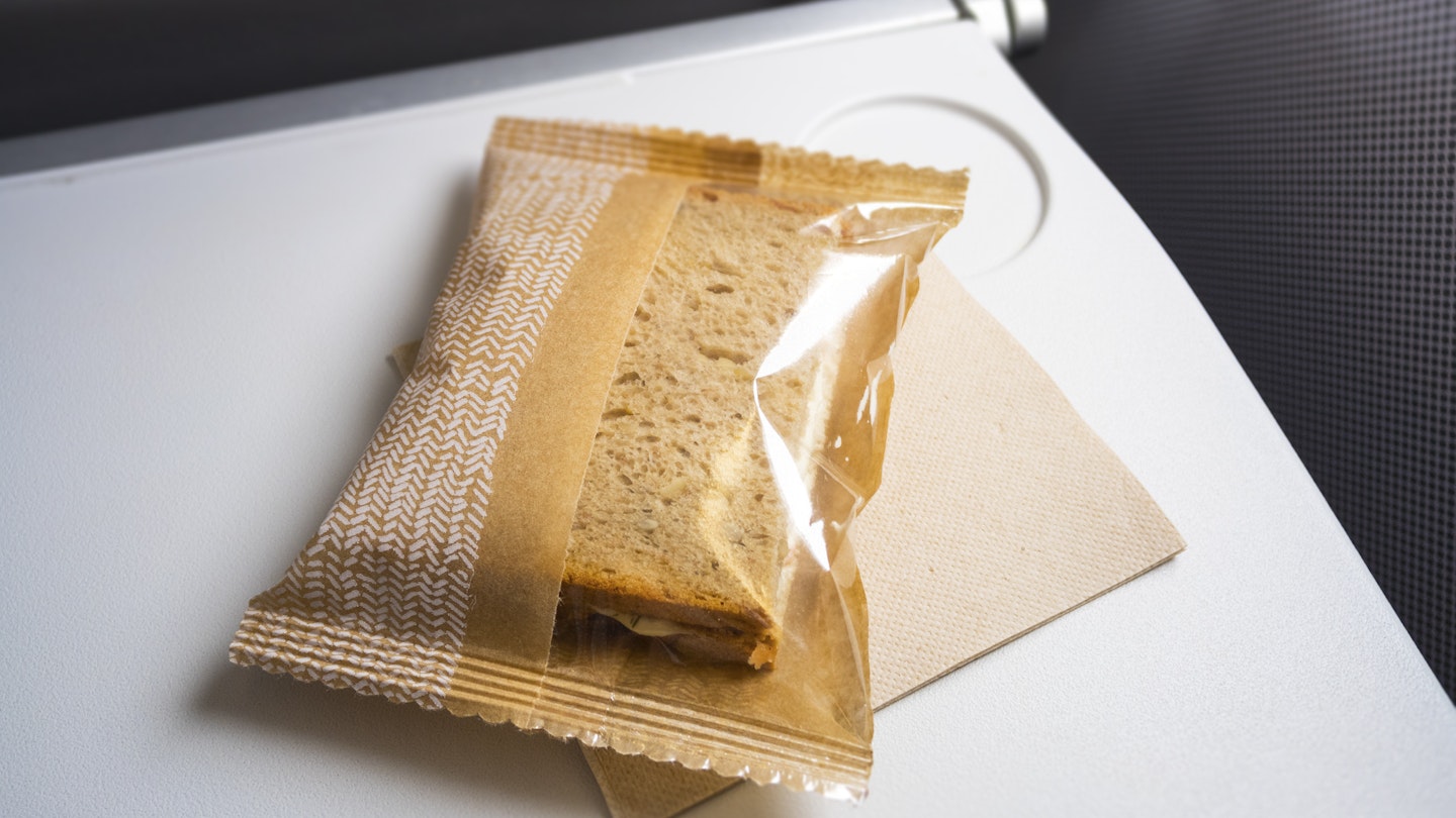 An image of a very small snack at the plane; Shutterstock ID 465639626; your: Fionnuala McCarthy; gl: 65050; netsuite: ONLINE EDITORIAL; full: airline food