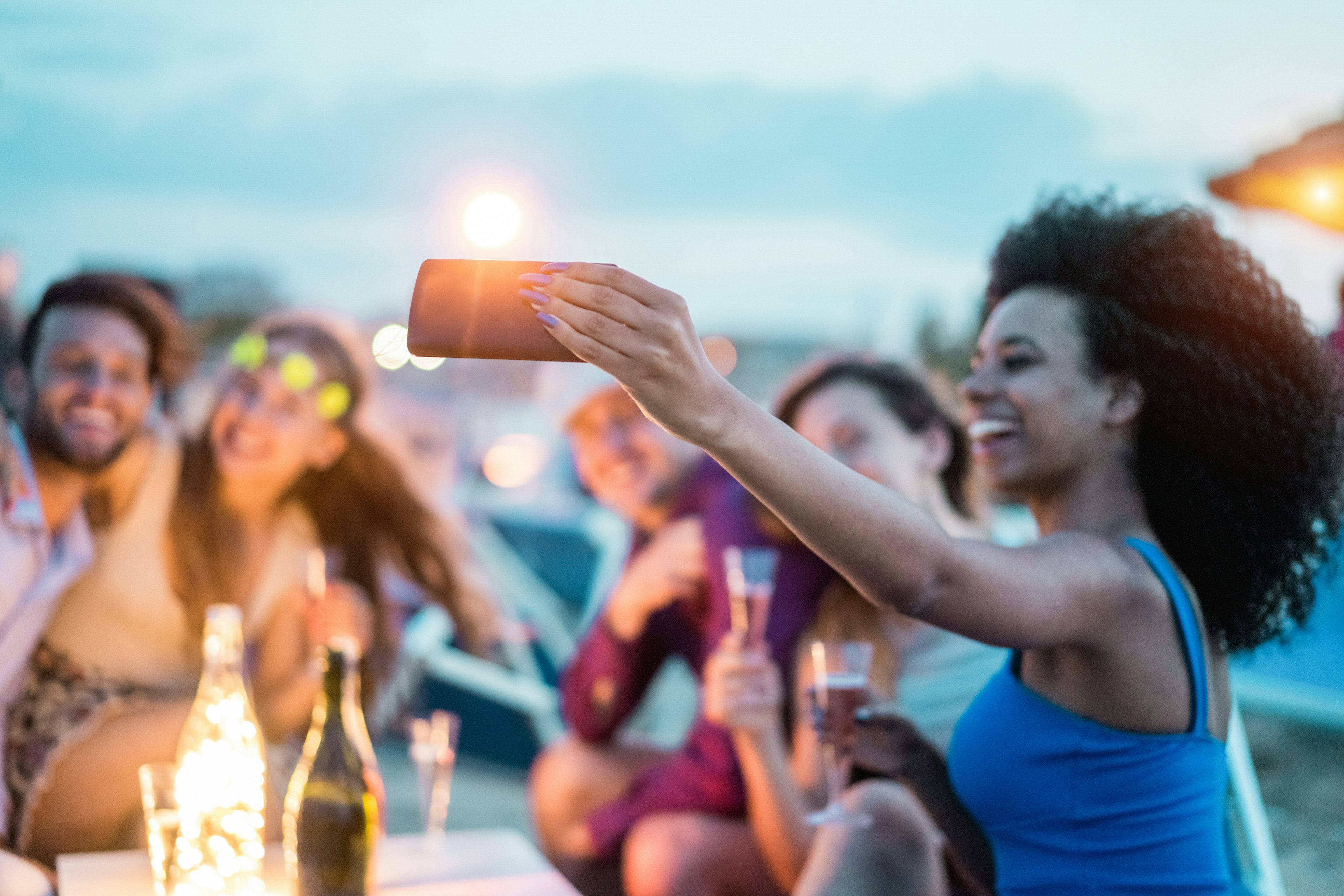 Happy friends take a selfie at the beach