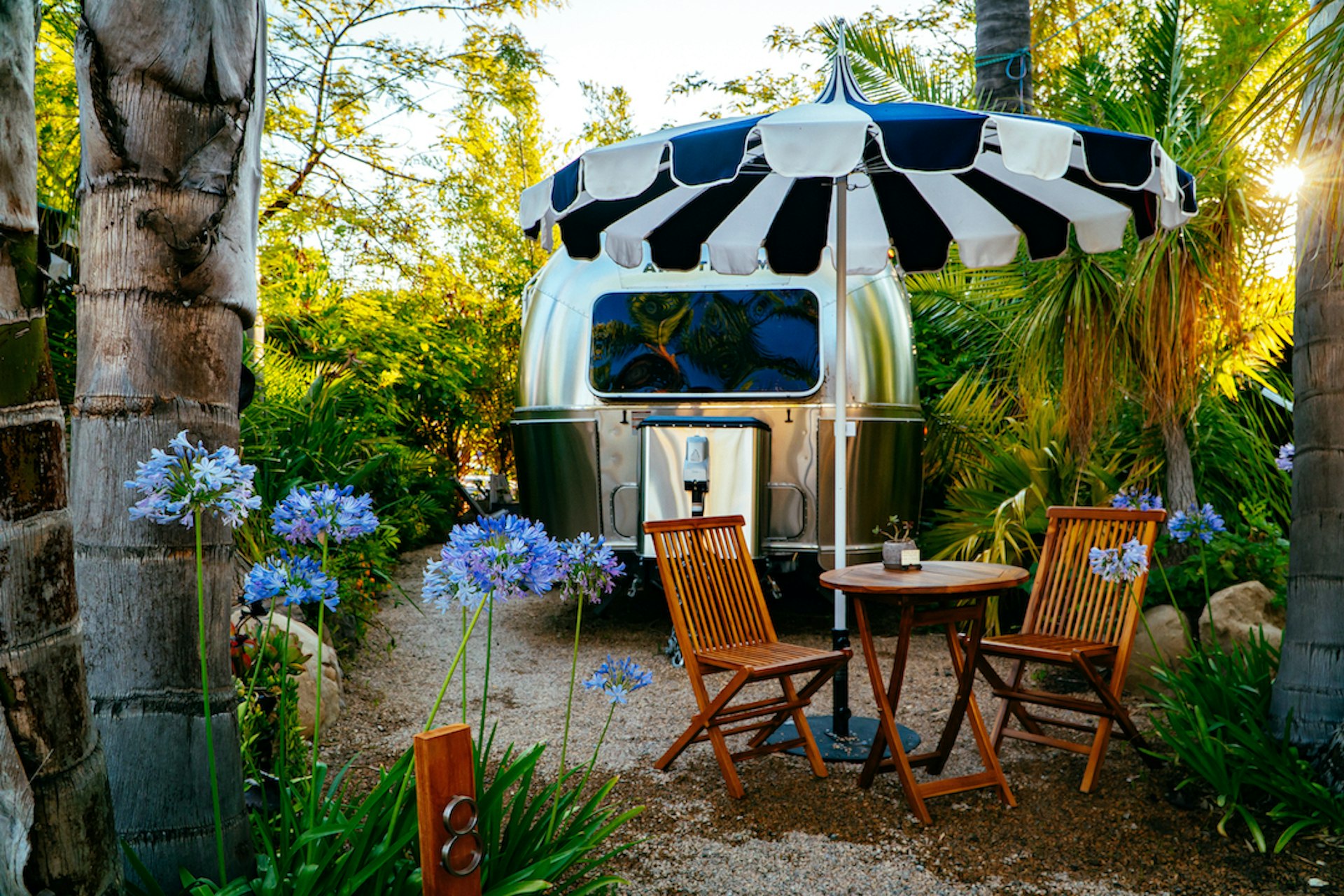 A table and chairs by a vintage trailer at Caravan Outpost in Ojai, California, USA