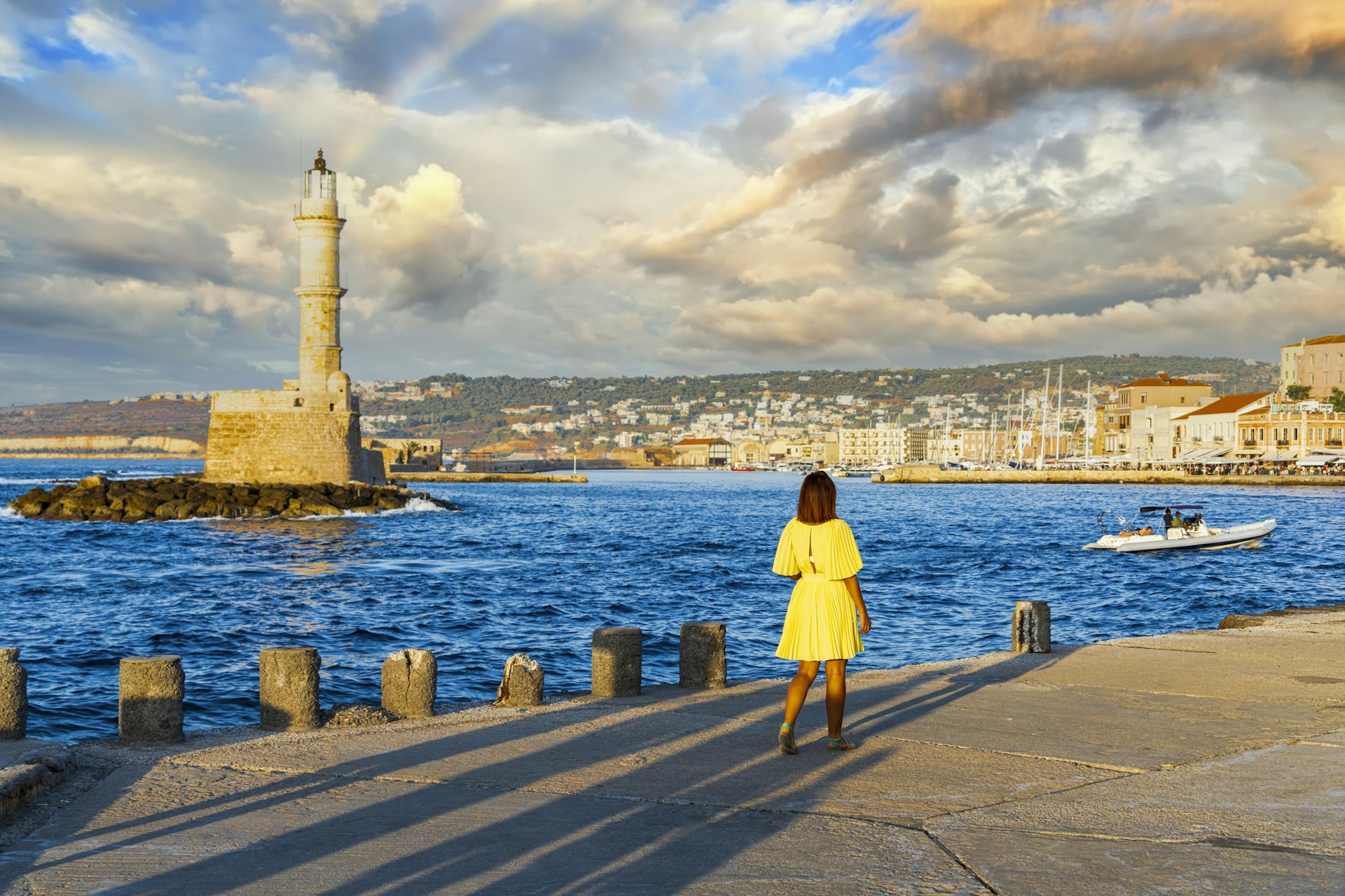 A woman admires the lighthouse in Hania, Greece