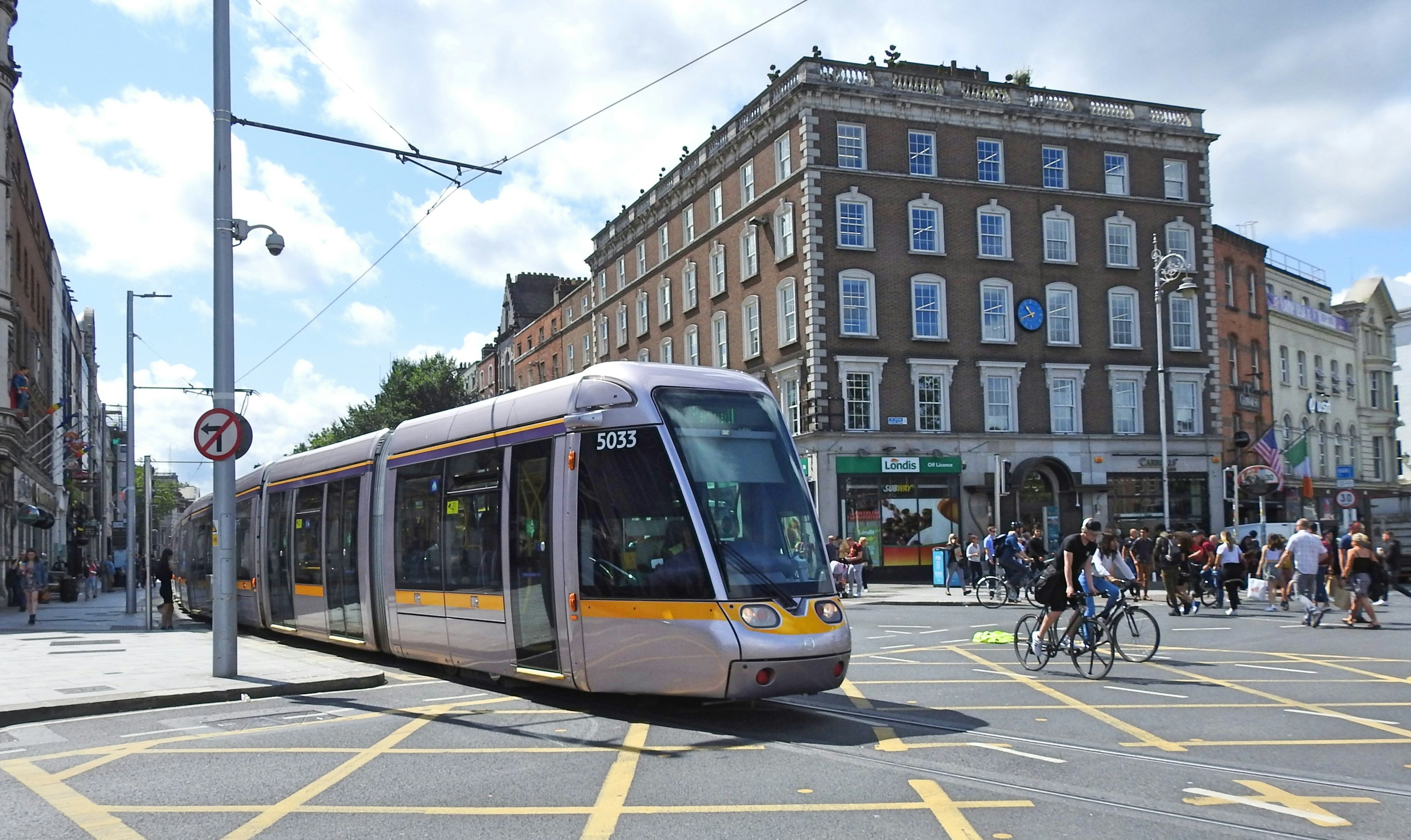 A light rail Luas tram train heading toward O'Connell Bridge in Dublin City Centre.