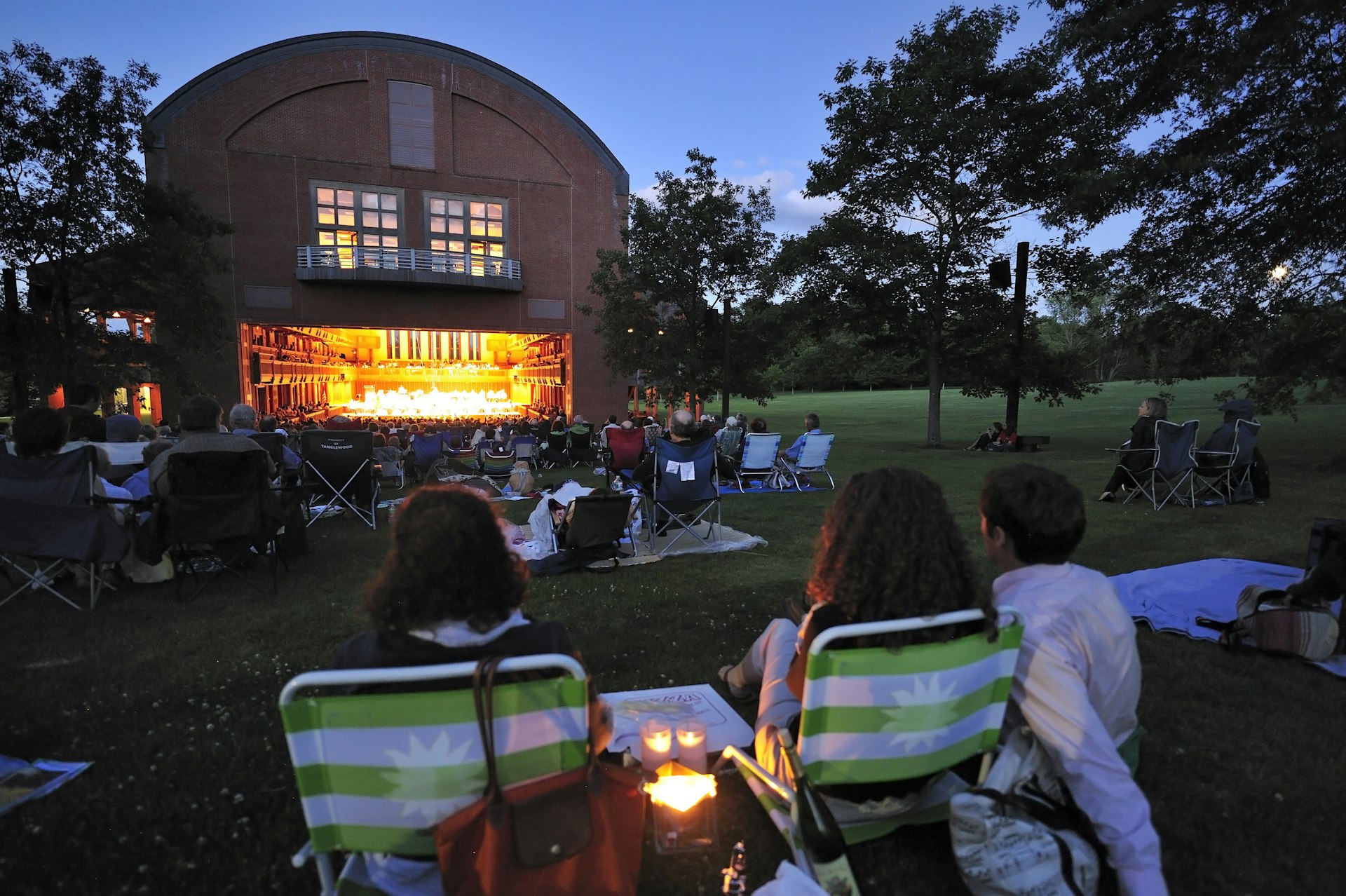 Crowds in folding chairs enjoy an open-air concert at Ozawa Hall, Tanglewood Music Festival, Berkshires, Massachusetts, USA