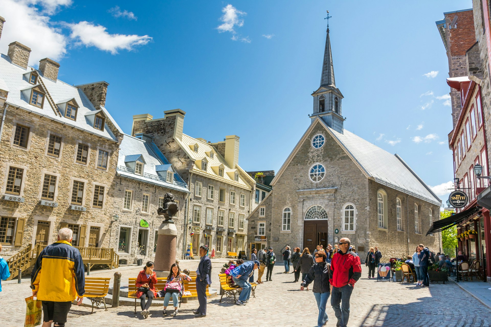People walk through a square in front of Notre-Dame-des-Victories church in Vieux Québec (Old Town), Québec City, Québec, Canada, North America