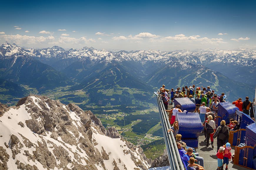 Tourists enjoying the breathtaking view from the extended Skywalk in Dachstein
