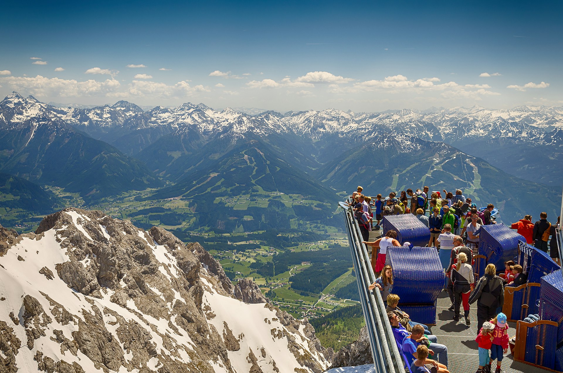 Tourists enjoying the breathtaking view from the extended Skywalk in Dachstein