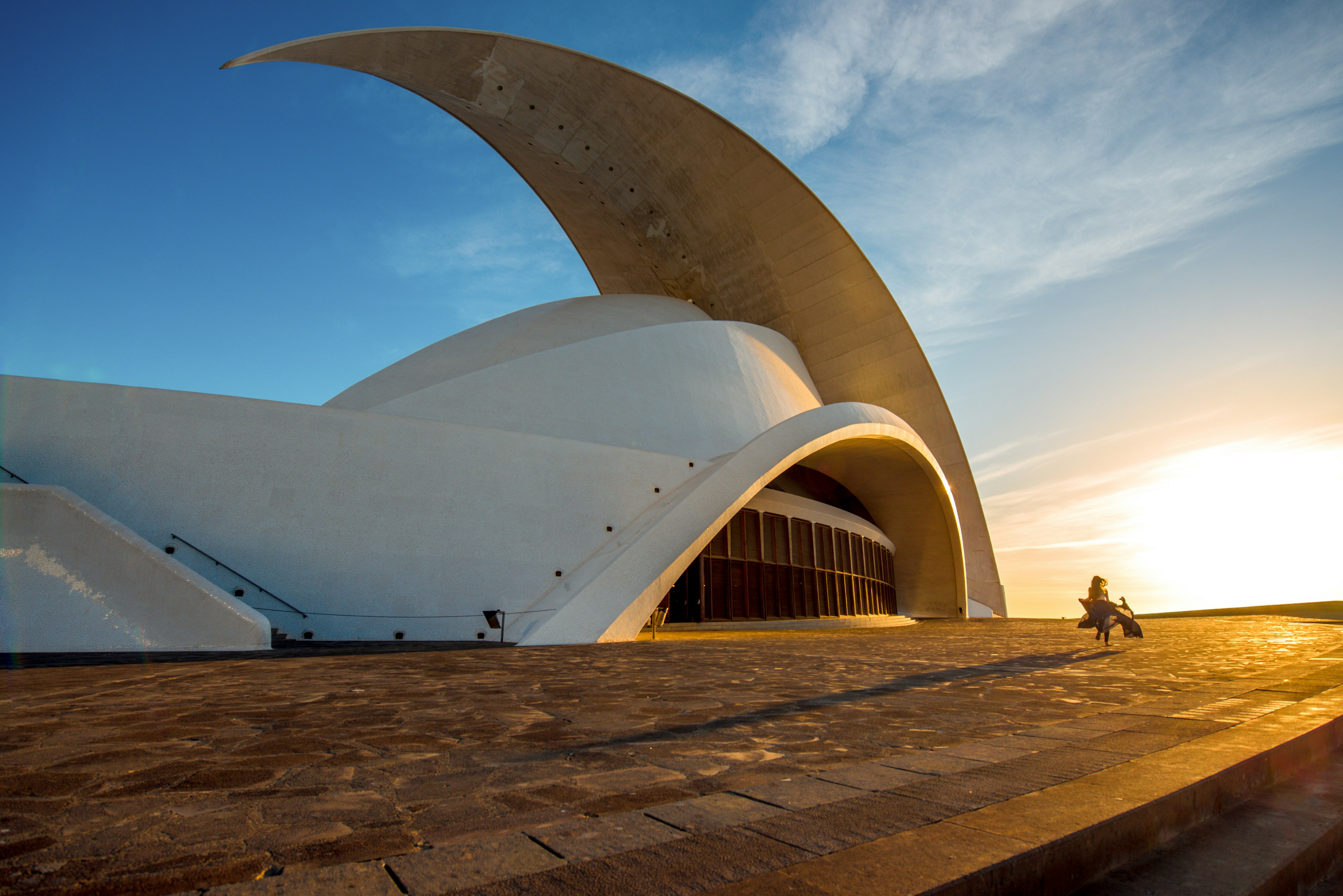 Woman with a flowing skirt walking past the Auditorio building in Santa Cruz de Tenerife