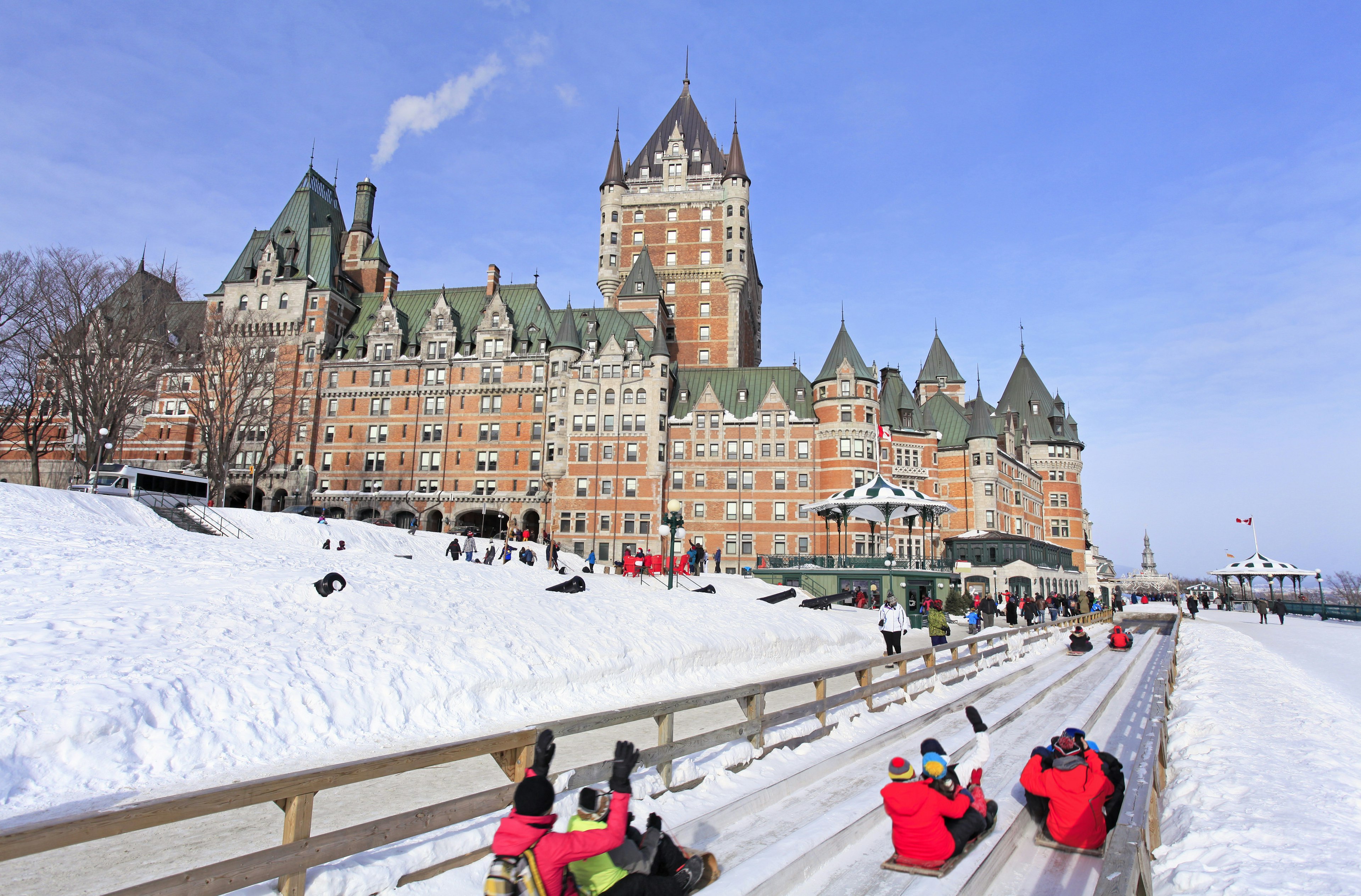 People slide down the track at the winter Glissade de la Terrasse in ϳé City, ϳé, Canada