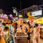 July 11, 2017: A crowd of people peruse food stalls at Shilin night market.