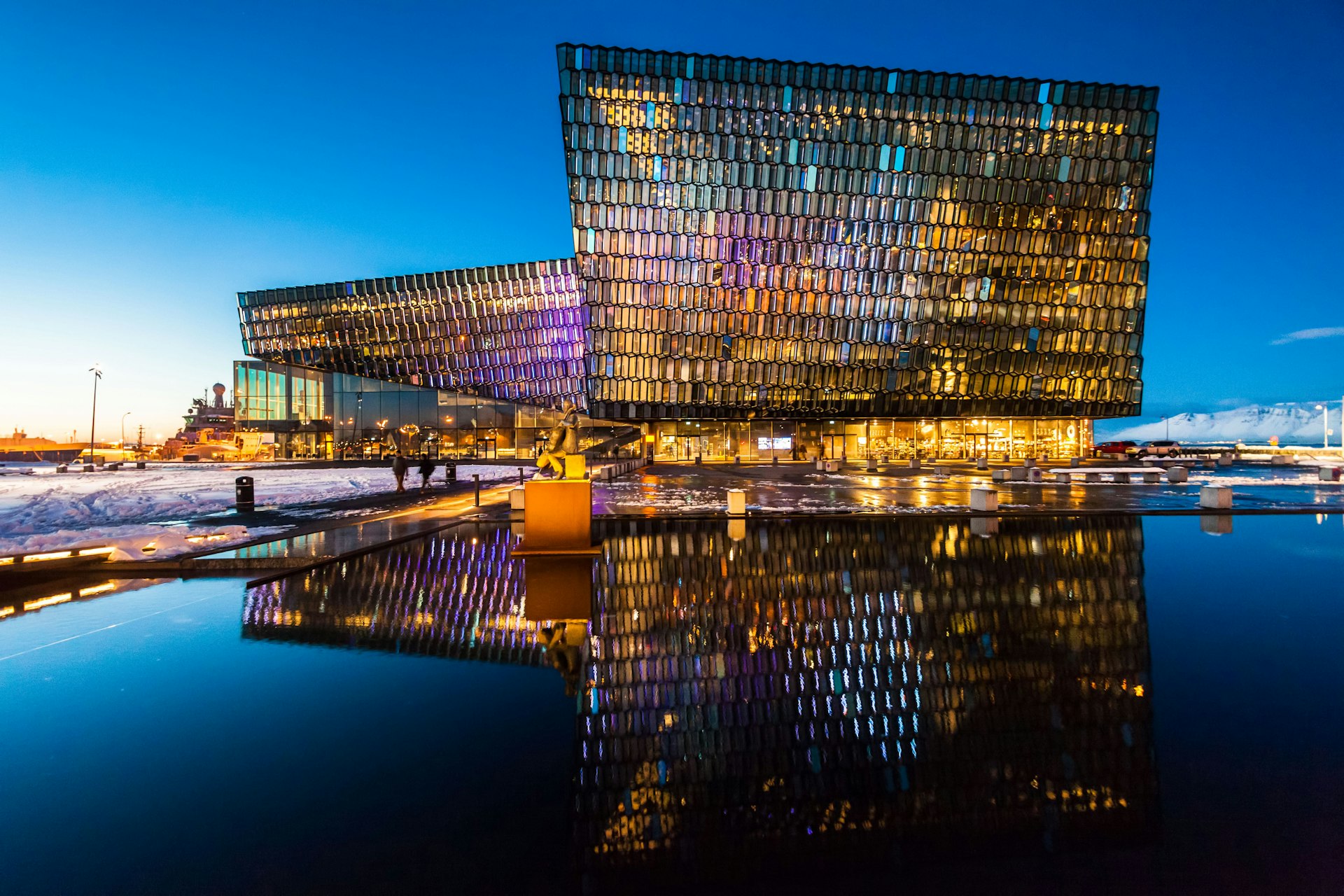 Exterior of the Harpa Concert Hall illuminated during twilight in Reykjavik Iceland