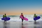 Matosinhos, Porto, Portugal- 17th November 2020: Sea Surfers with colorful dresses and boards are going to surf in the Atlantic Ocean in Porto City of Portugal