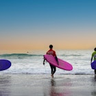 Matosinhos, Porto, Portugal- 17th November 2020: Sea Surfers with colorful dresses and boards are going to surf in the Atlantic Ocean in Porto City of Portugal