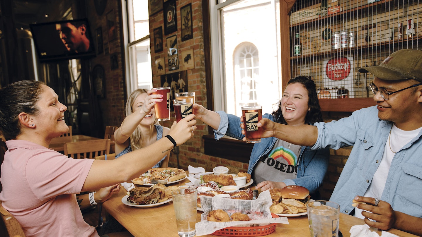 group of friends enjoying snacks and beer at Maumee Bay Brewing in Toledo OH