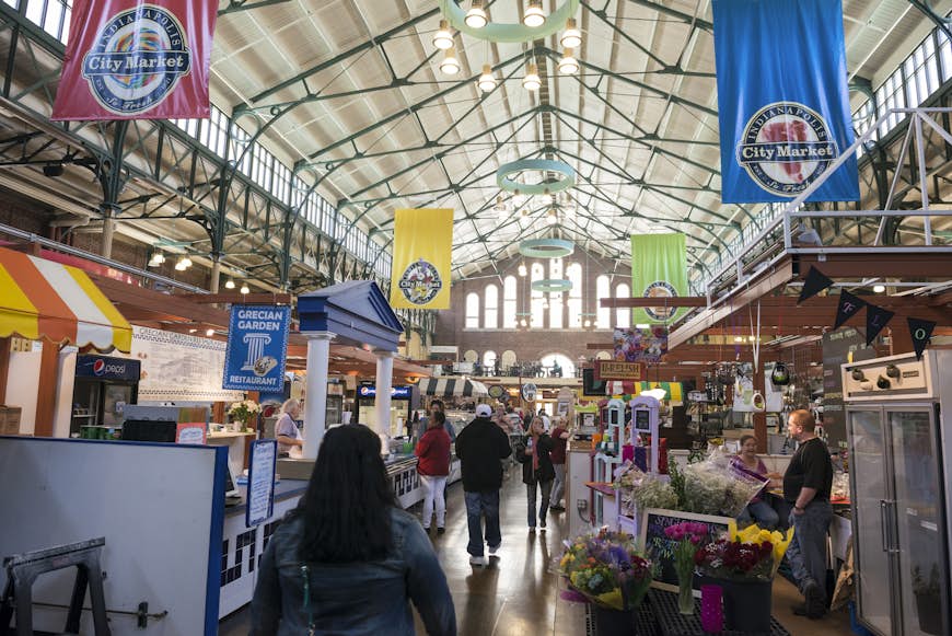 Shoppers walk through City Market in Indianapolis on a path lined with food stalls