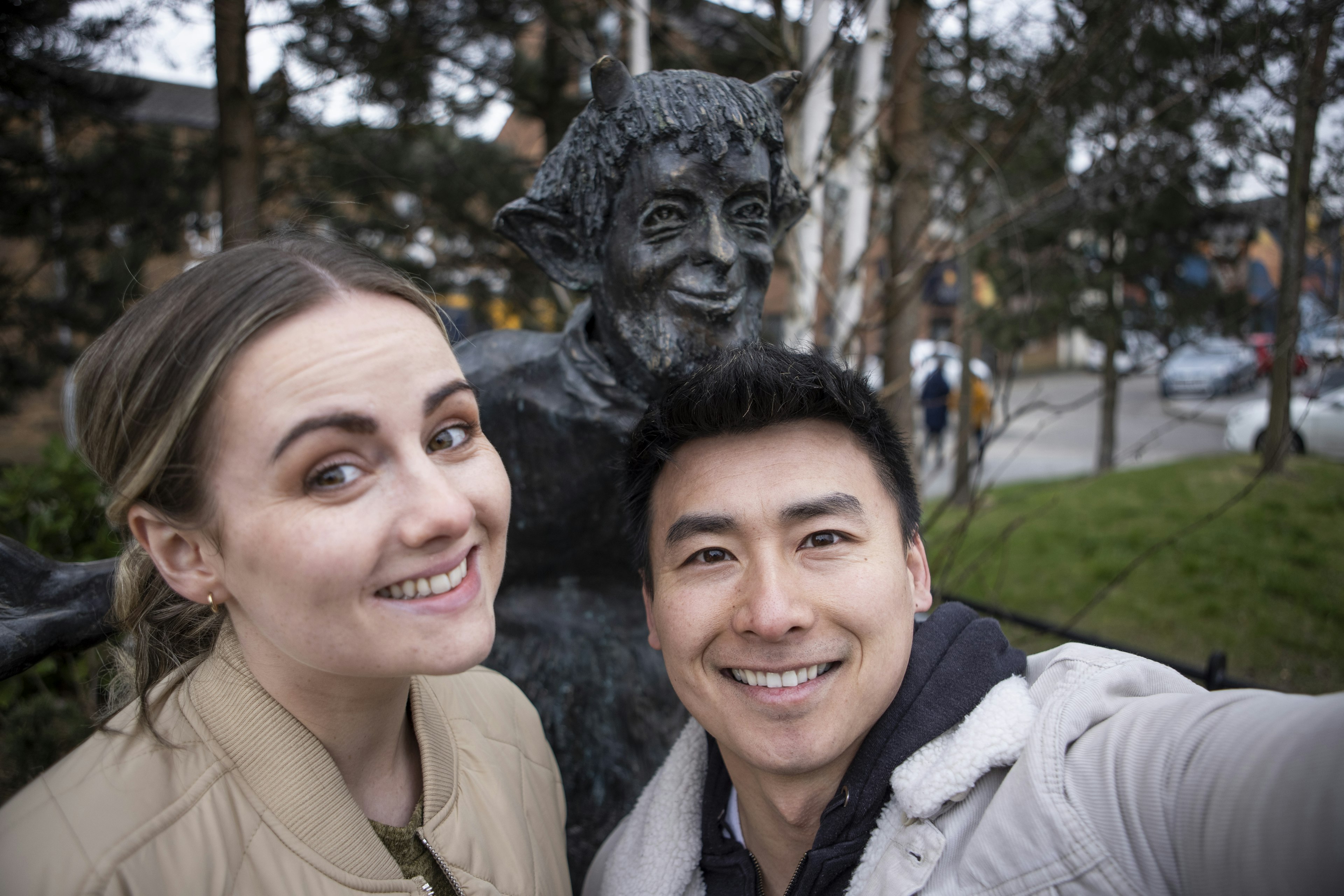 Couple in front of Mr Tumus sculpture at C S Lewis Square Belfast