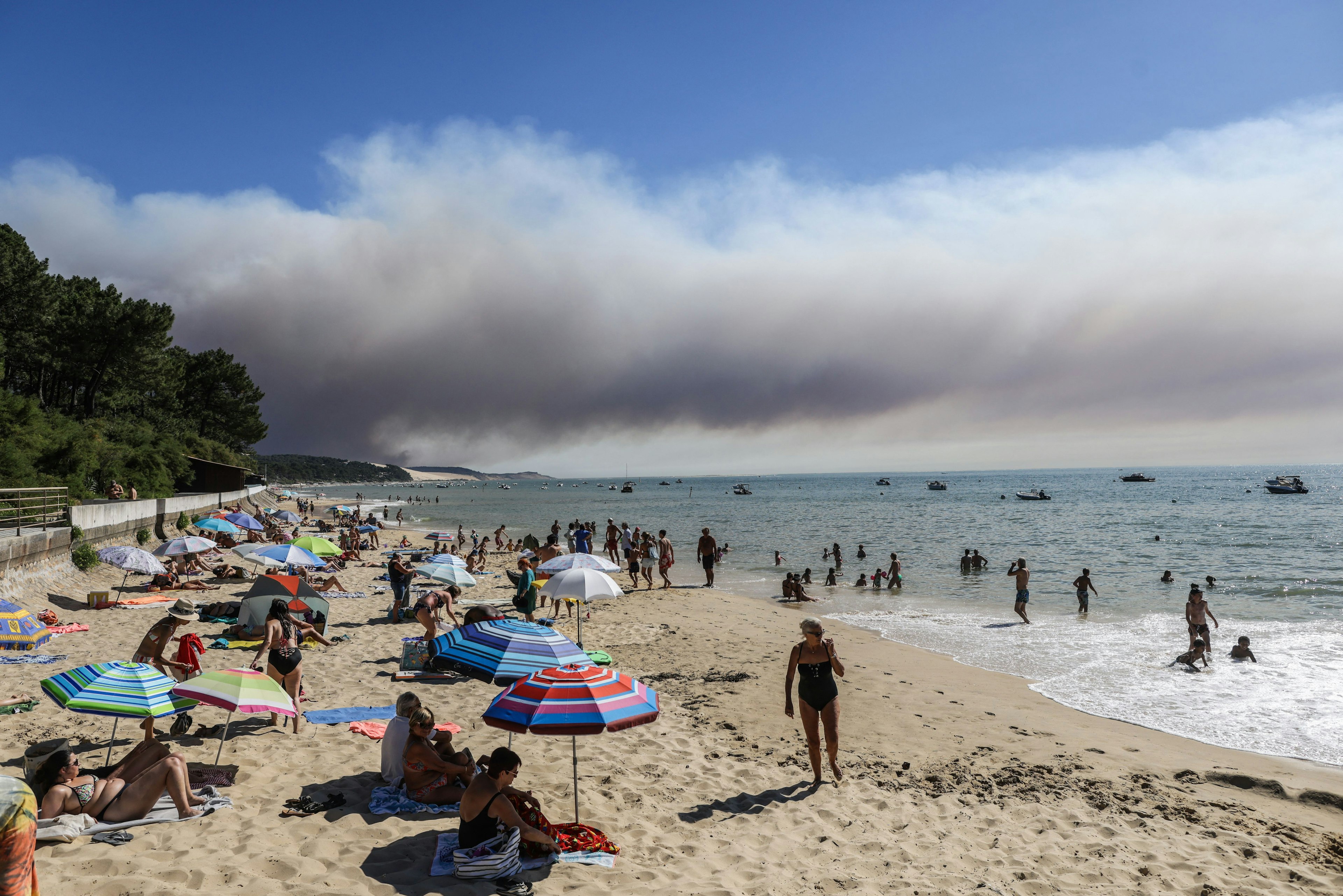 Beach-goers bathe and lay at a beach of