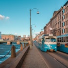 Gothenburg, Sweden - April 2, 2013: Blue old electric trams at a street by a canal, in the centre of Göteborg, important Scandinavian city of Sweden.