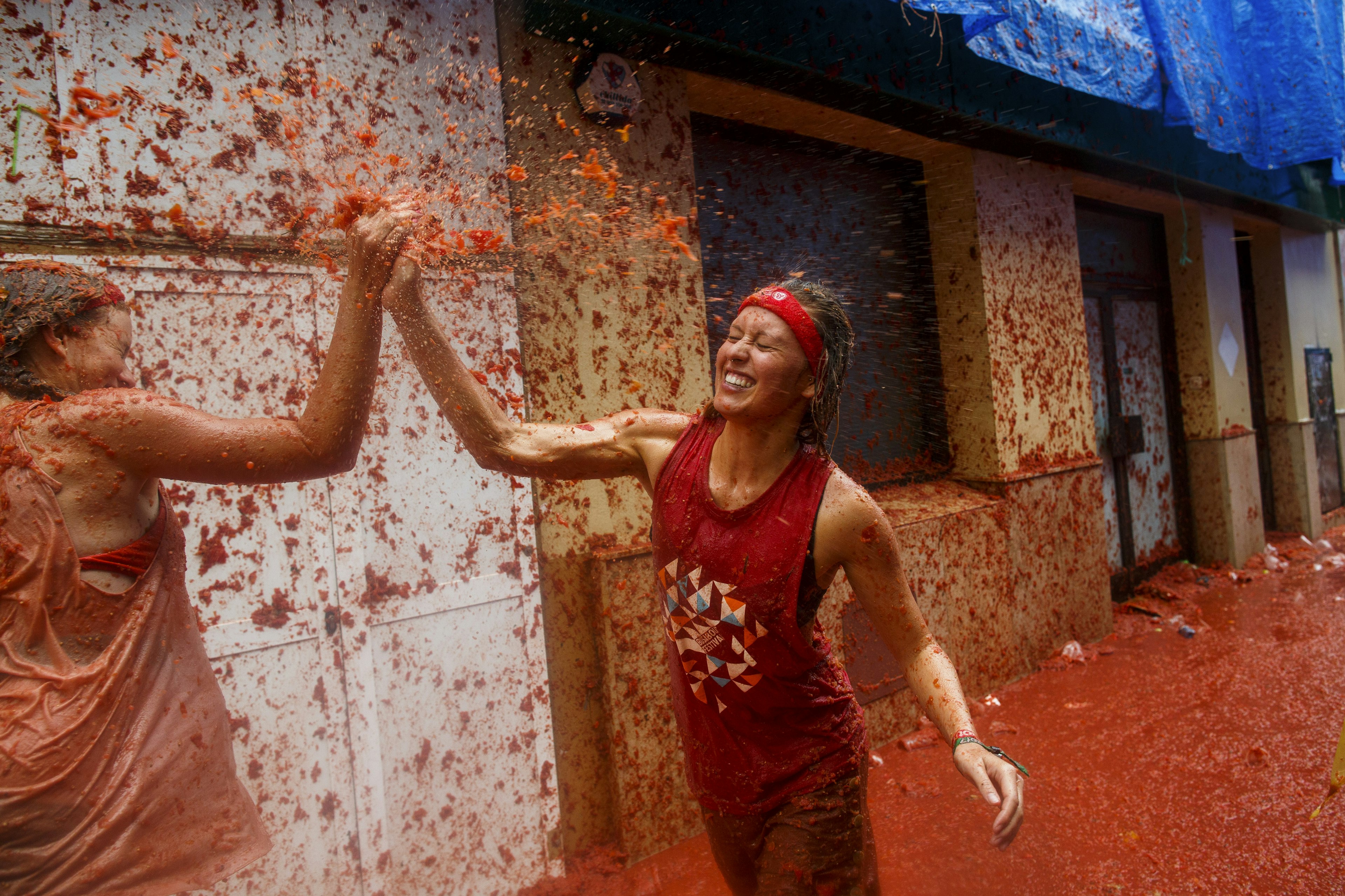 Revelers enjoying the tomato pulp atmosphere of La Tomatina