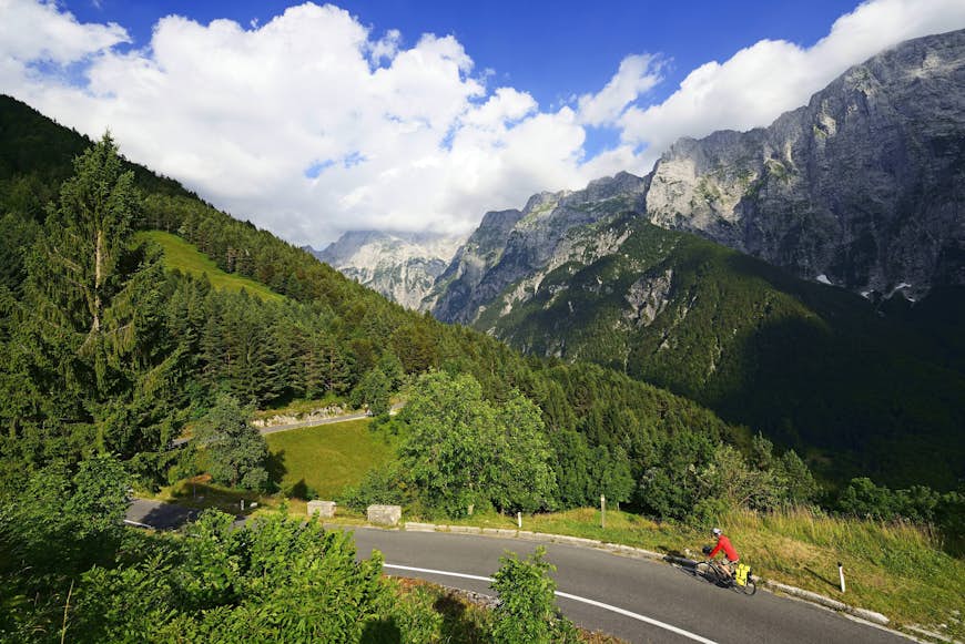A cyclist climbs a hill on the road to Mangart Pass in Kranjska Gora, Slovenia