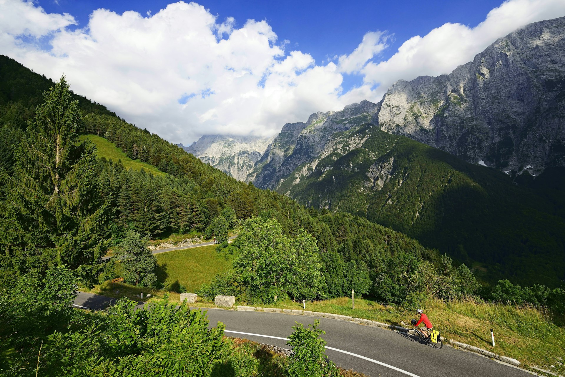 A cyclist climbs a hill on the road to Mangart Pass in Kranjska Gora, Slovenia