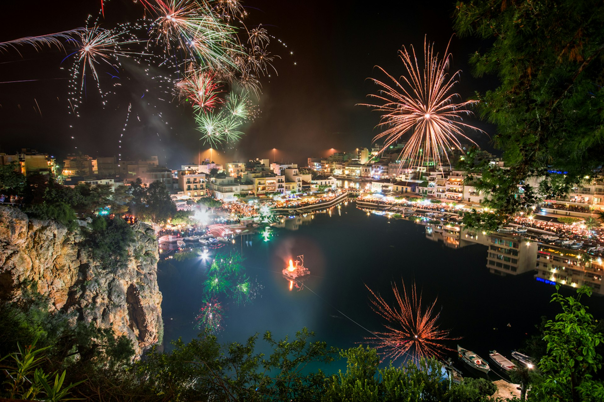 Fireworks light up the night sky above a coastal town