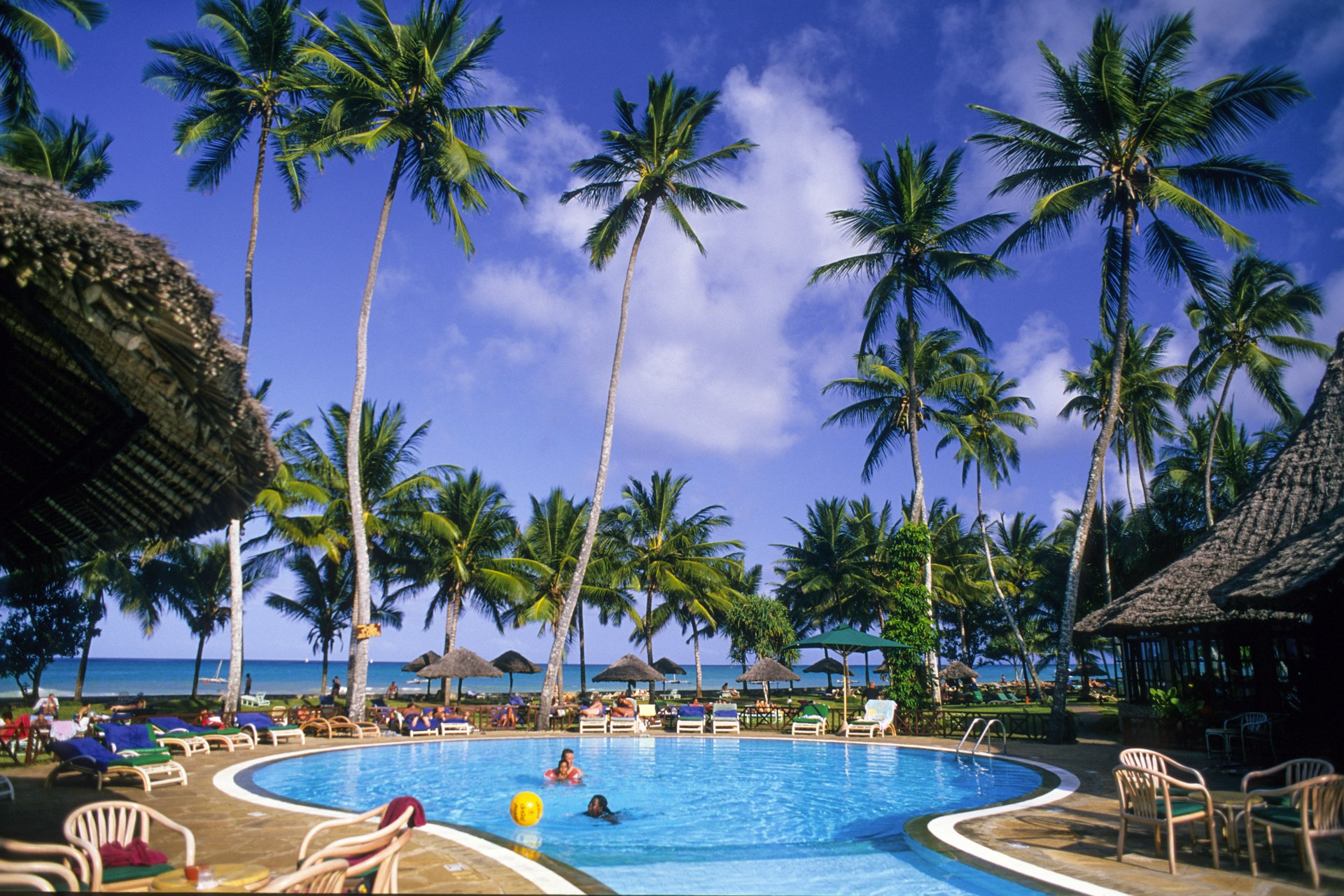 A family enjoying the pool at a beach resort in Malindi, Kenya