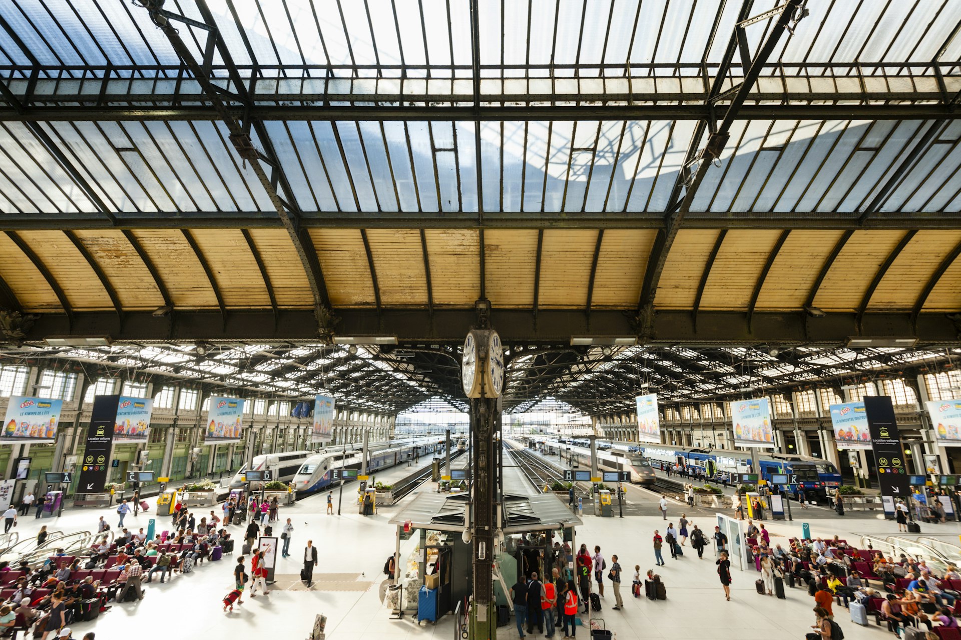 Passengers and trains at Lyon's busy railway station 