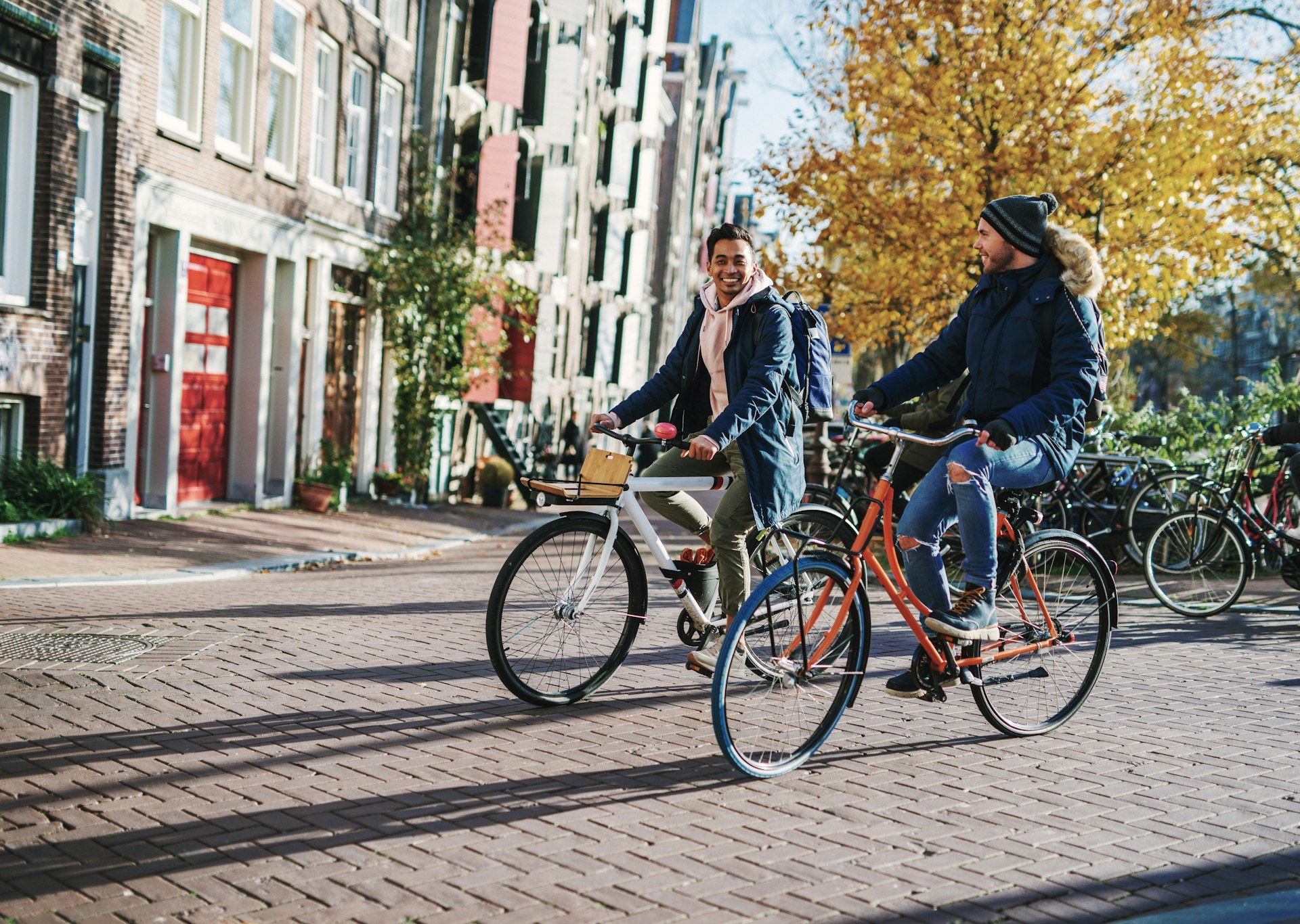 A couple bikes down a road in Amsterdam