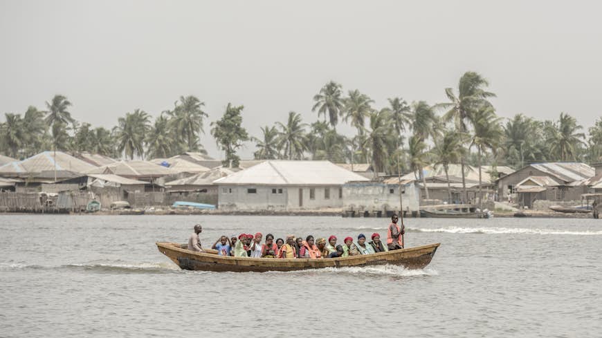 A group of people on a small ferry boat across Lagos Creek, Lagos, Nigeria, Africa