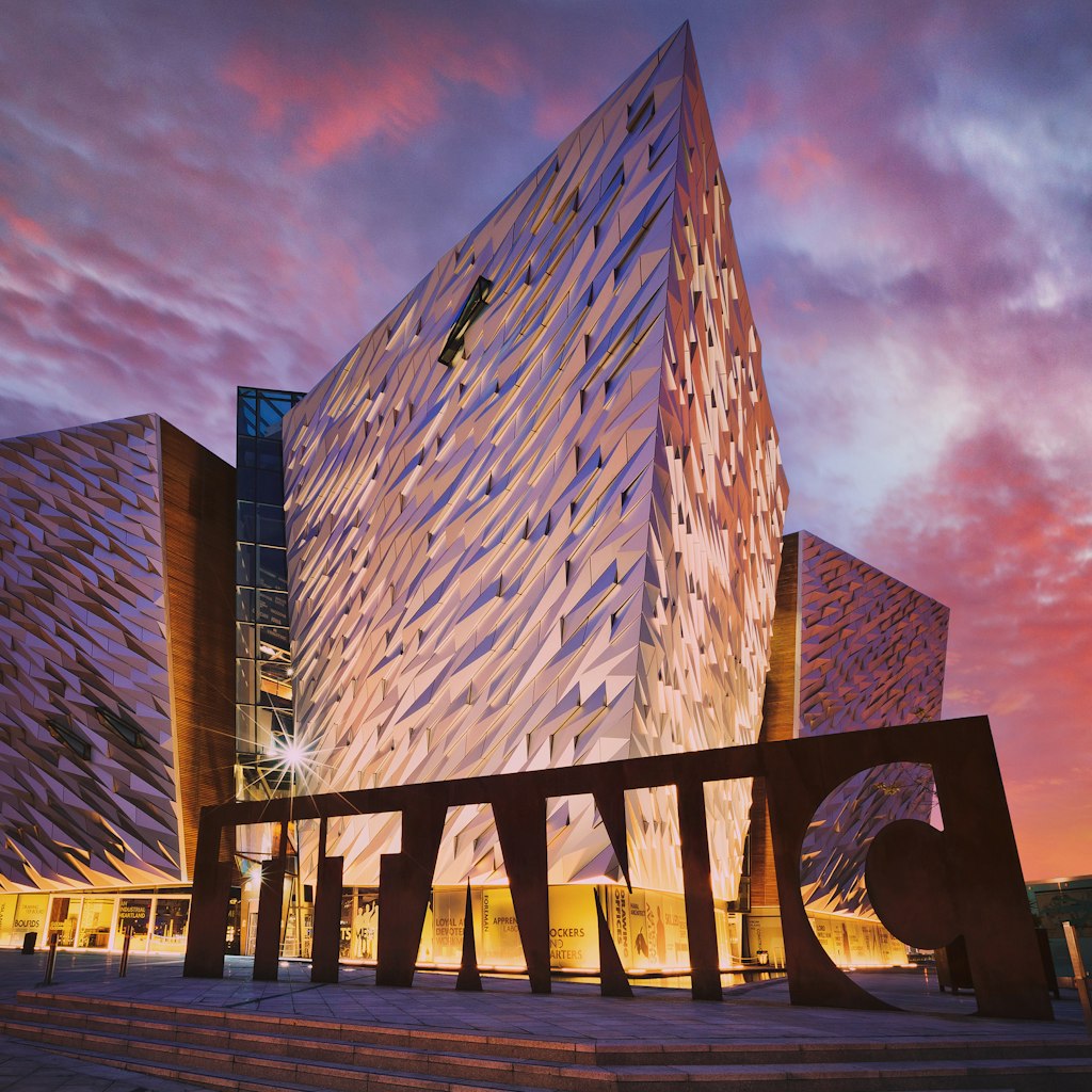 BELFAST, NORTHERN IRELAND - JUNE 28, 2017: Sunset over Titanic Belfast - museum, touristic attraction and monument to Belfast's maritime heritage on the site of the former Harland and Wolff shipyard.; Shutterstock ID 1847358820; your: Jennifer Carey; gl: 65050; netsuite: Online Editorial; full: Belfast best museums