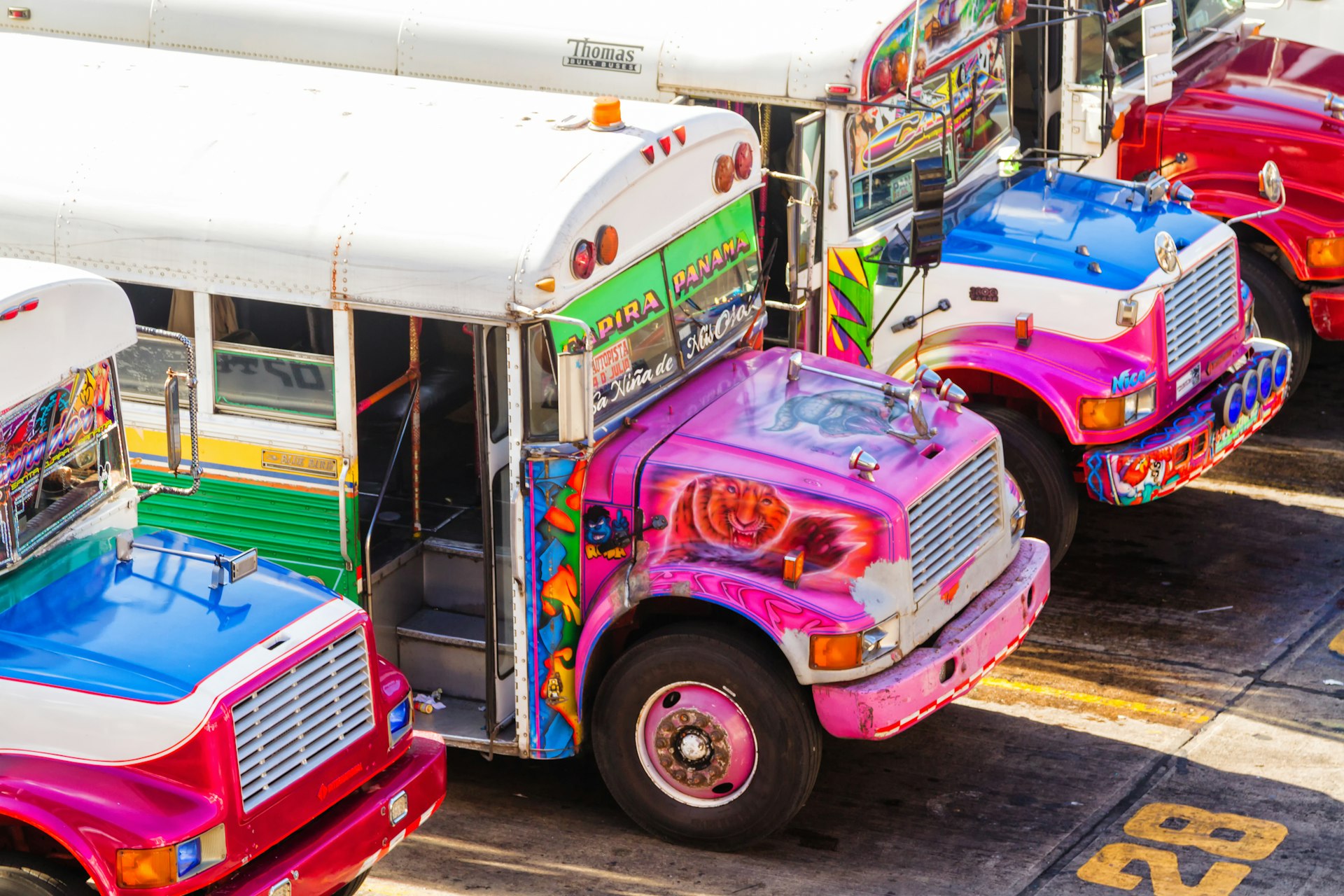 Vividly colorful chicken buses waiting for passengers in Panama