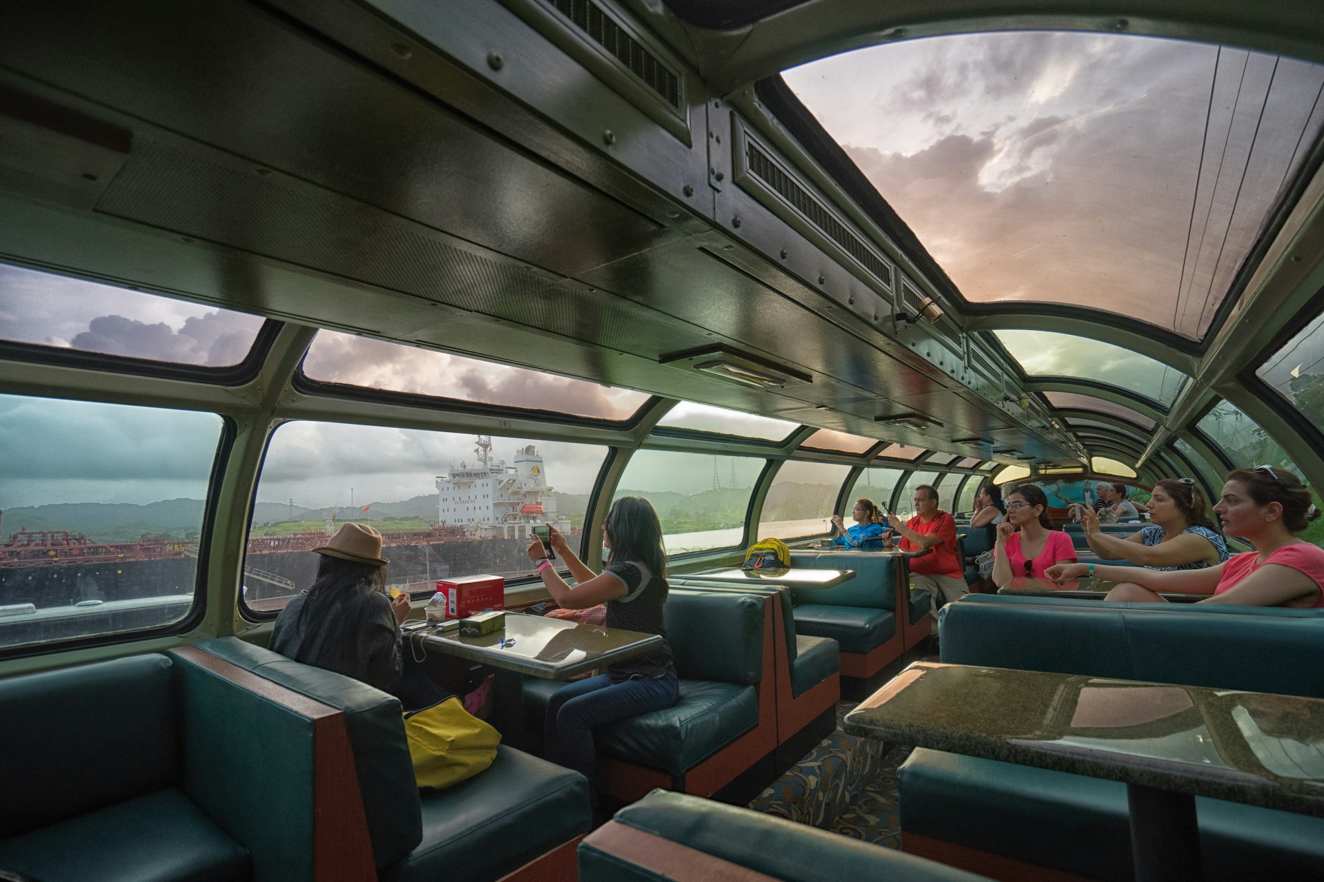 Tourists taking photos from the observation car on the Panama Canal Railway