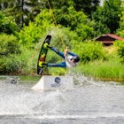 Wakeboarder surfing across  the Bagry lake in Krakow, Poland. 23-06-2015; Shutterstock ID 1217525815; your: Claire Naylor; gl: 65050; netsuite: Online editorial ; full: Krakow swimming