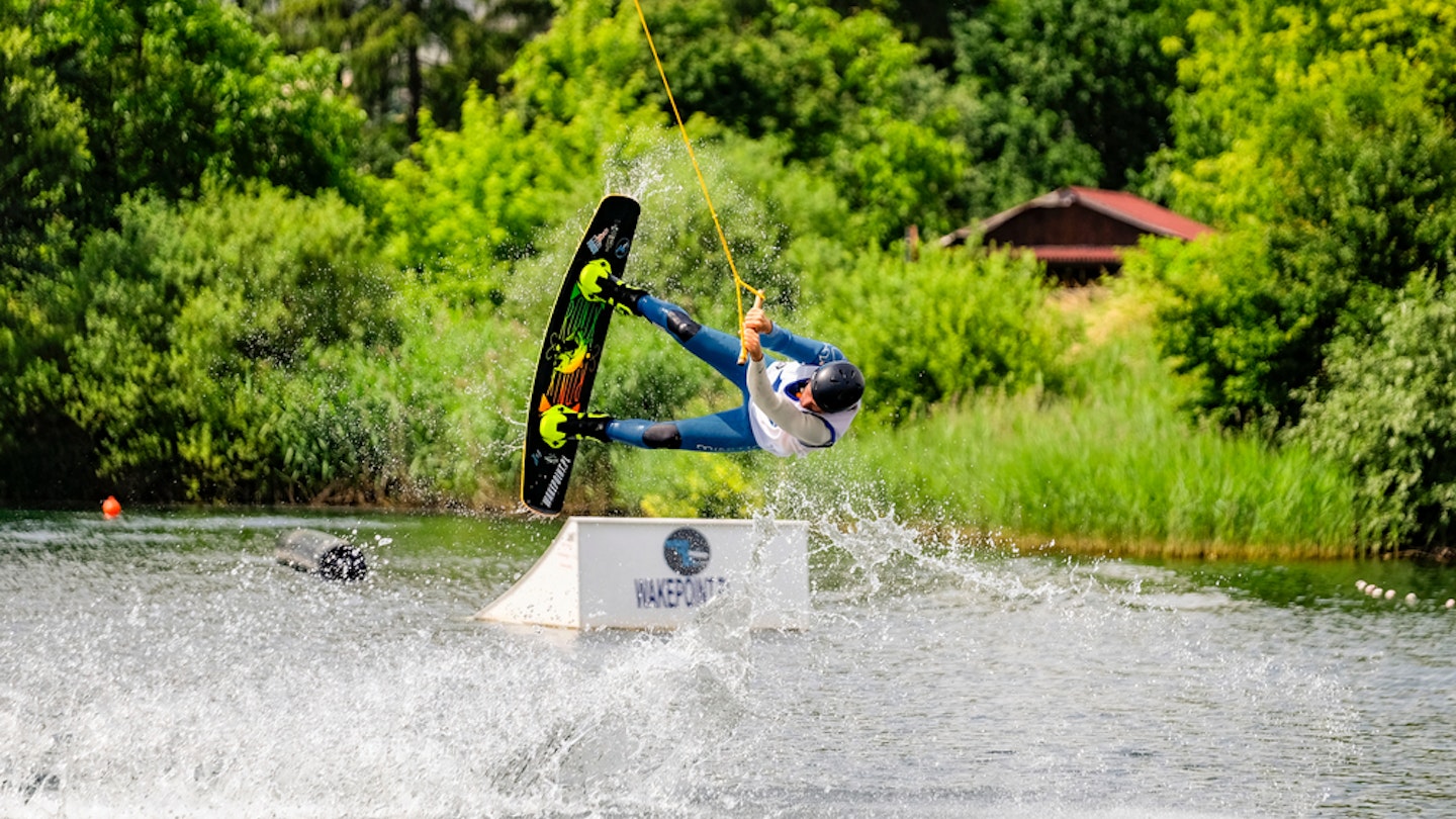 Wakeboarder surfing across  the Bagry lake in Krakow, Poland. 23-06-2015; Shutterstock ID 1217525815; your: Claire Naylor; gl: 65050; netsuite: Online editorial ; full: Krakow swimming