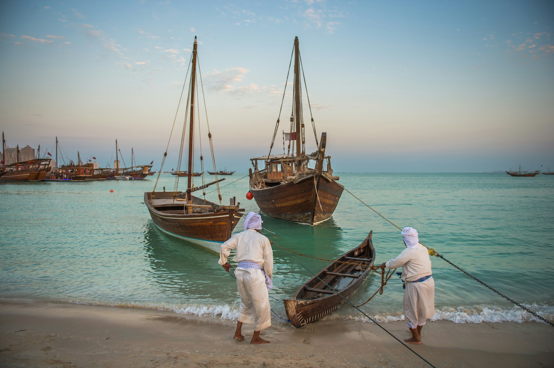 Sailors pull in a traditional dhow boats at the Katara Traditional Dhow Festival, Doha, Qatar, Middle East