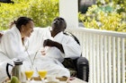 Young couple laughing on the porch of their resort cabin in South Carolina