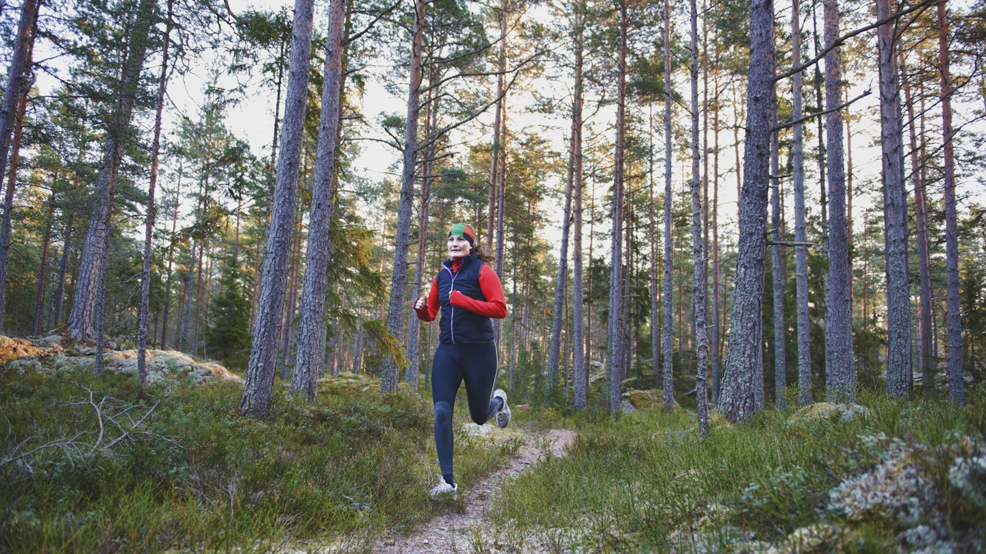 A woman running in the forest in Sweden