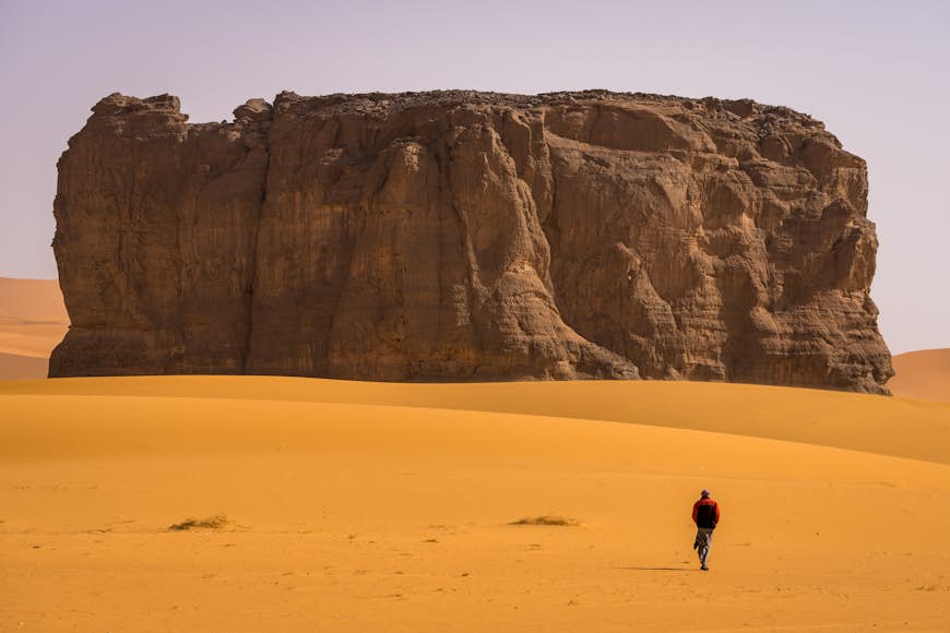 Abdessalam in front of a rock plateau in Tassili National Park