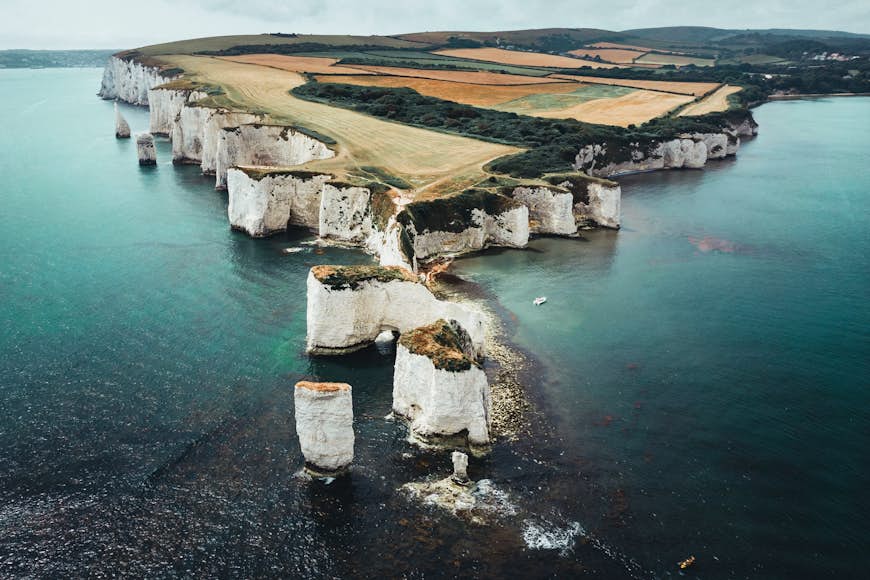 An aerial view of the chalk-white sea stacks called Old Harry Rocks